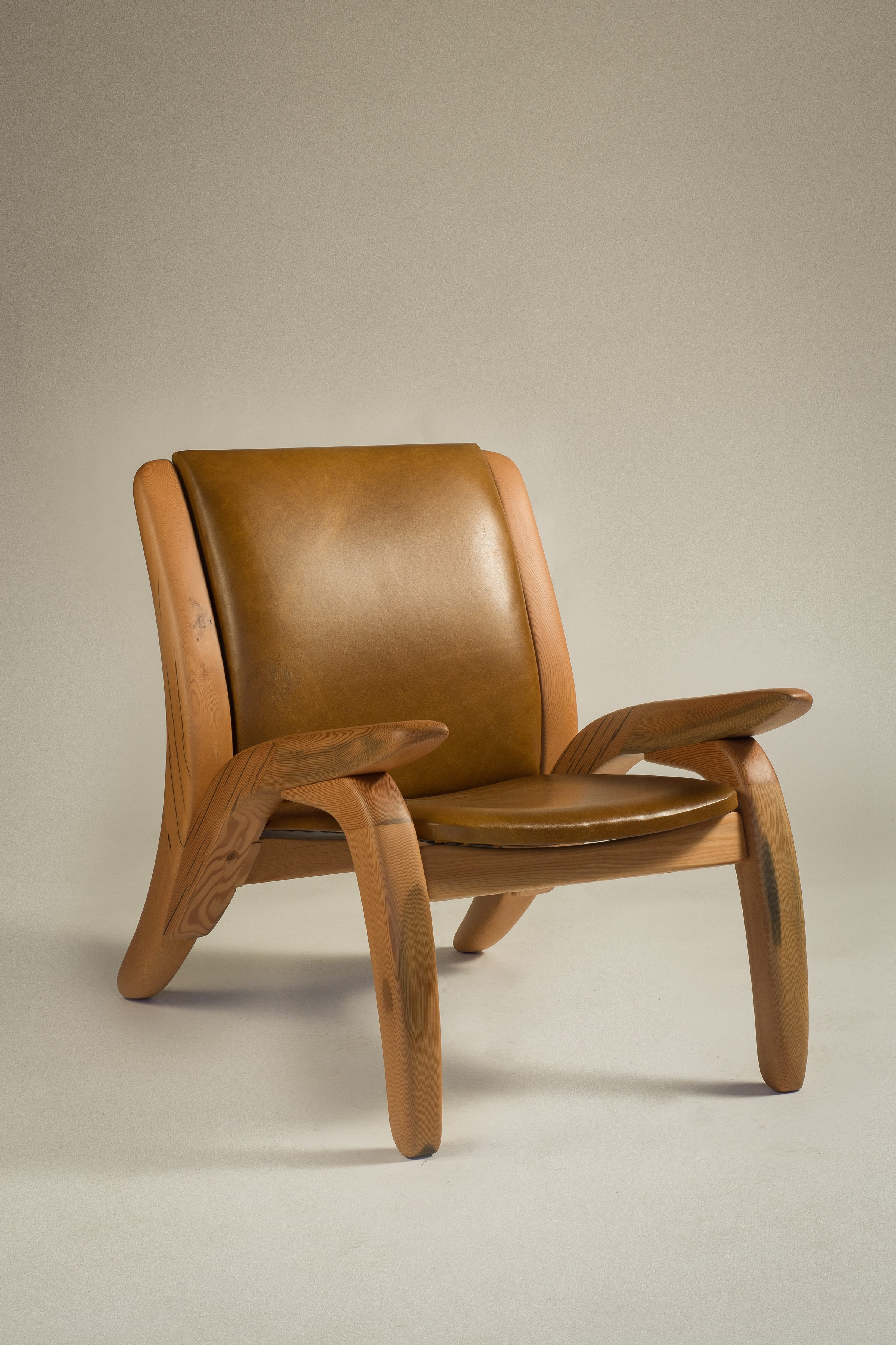 Wooden lounge chair shown from a three-quarter angle