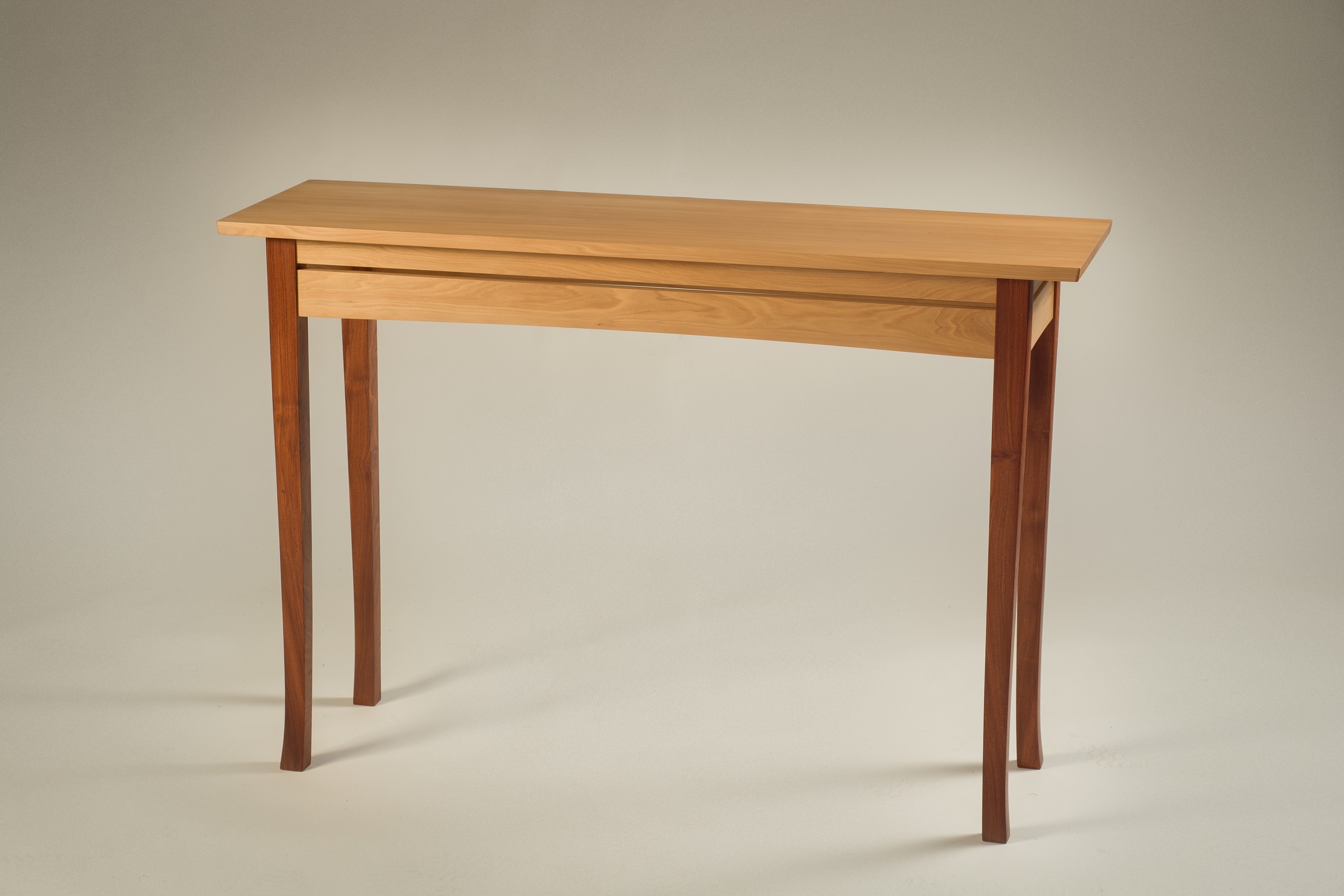 Wooden console table shown from a three-quarter angle