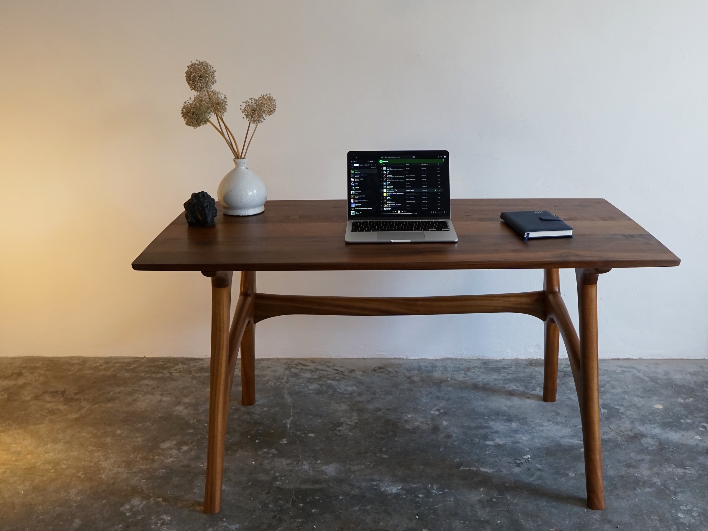 Sculptural Desk styled with a laptop and vase